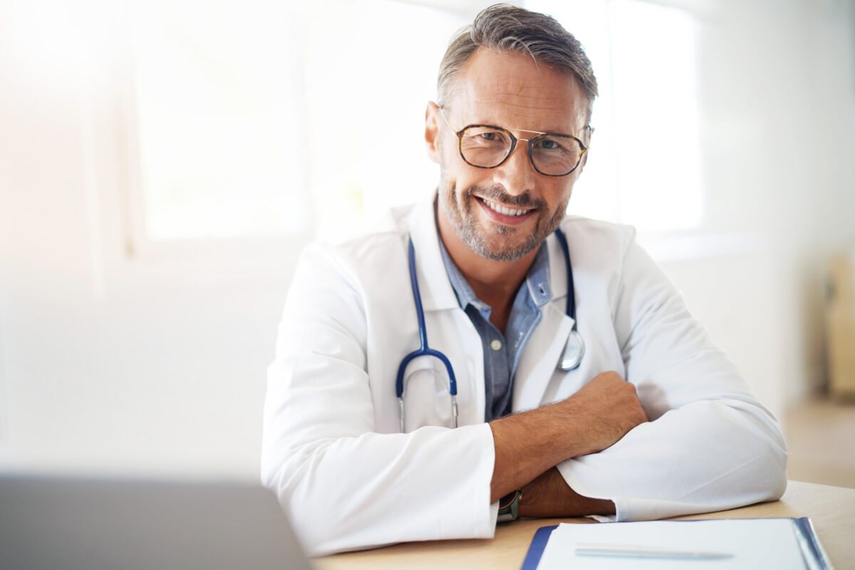 Portrait of mature, doctor sitting in medical office