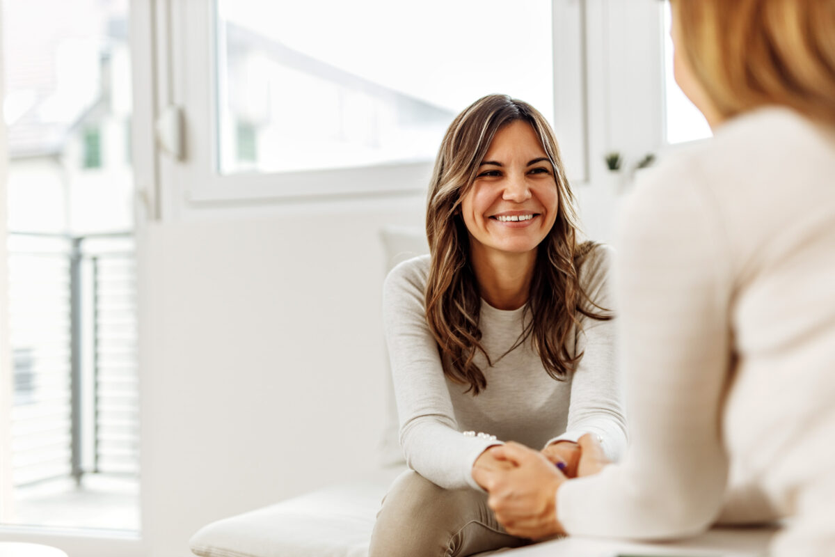 Smiling woman, talking to psychologist, feeling positive.